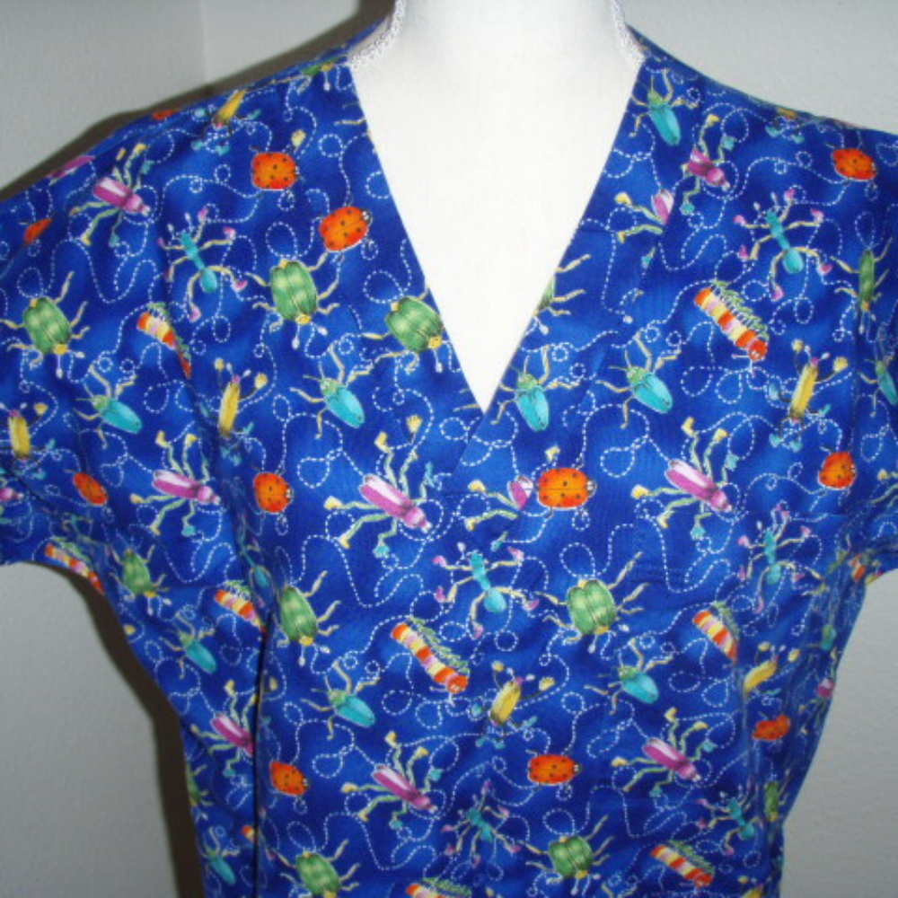 NWOT Bright Blue with Insect Pattern Scrub Top